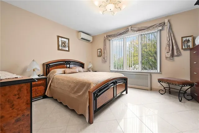 a bedroom with a bed chair and window