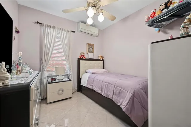 a bedroom with a bed dresser and a window