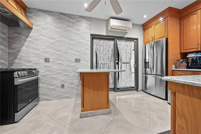 a view of a kitchen with stainless steel appliances granite countertop a refrigerator and a stove