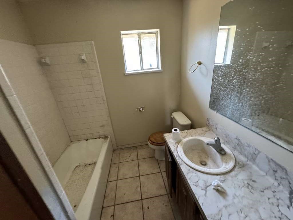 5996 Yucca Trail Beeville, TX 78102 - Photo 11 of 20 a bathroom with a sink a toilet and shower