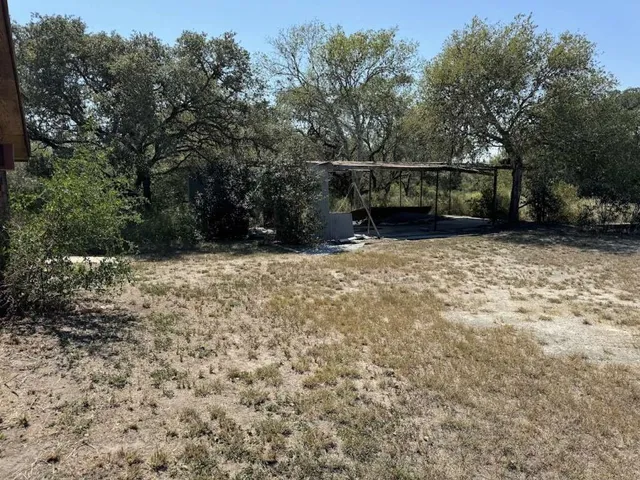 a view of house with trees in the background