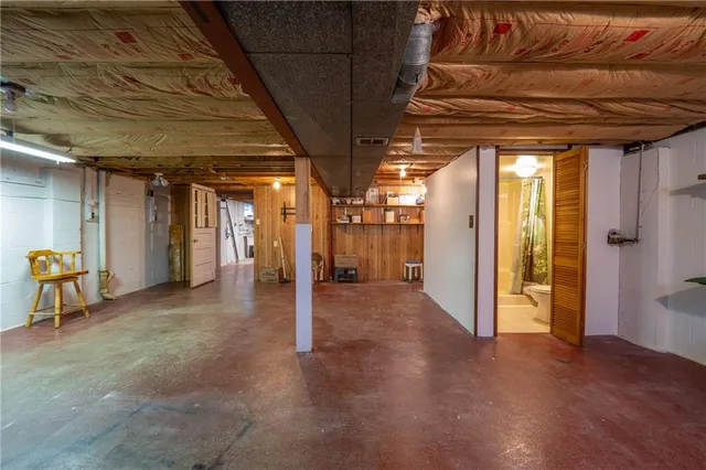 a view of empty room with wooden walls