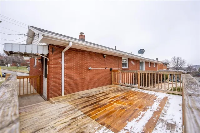 a view of a house with wooden fence