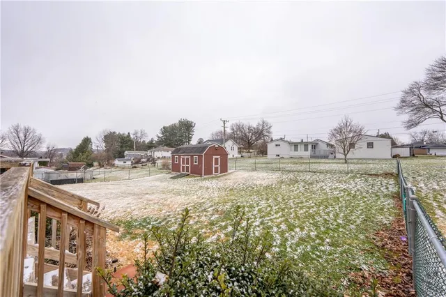 a view of a house with a yard and sitting area