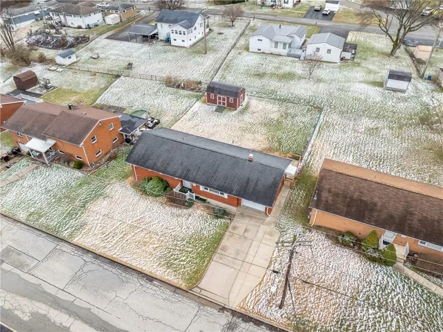 an aerial view of a house with outdoor space