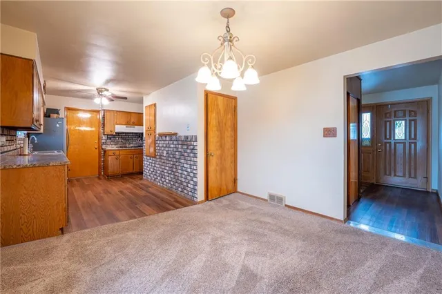 a view of a kitchen with a sink and a chandelier