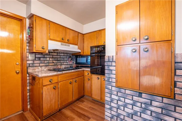 a kitchen with stainless steel appliances granite countertop a sink and cabinets