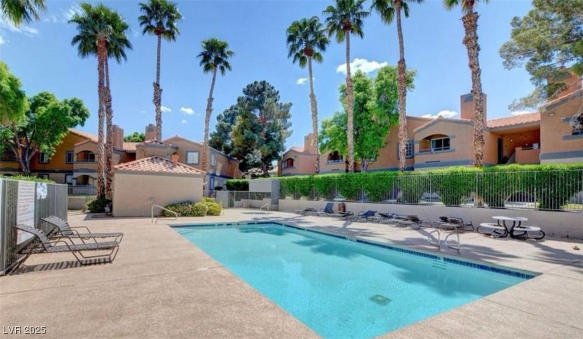 221 Mission Newport Lane, Unit 205 Las Vegas, NV 89107 - Photo 3 of 11 Community pool featuring a patio area and a residential view
