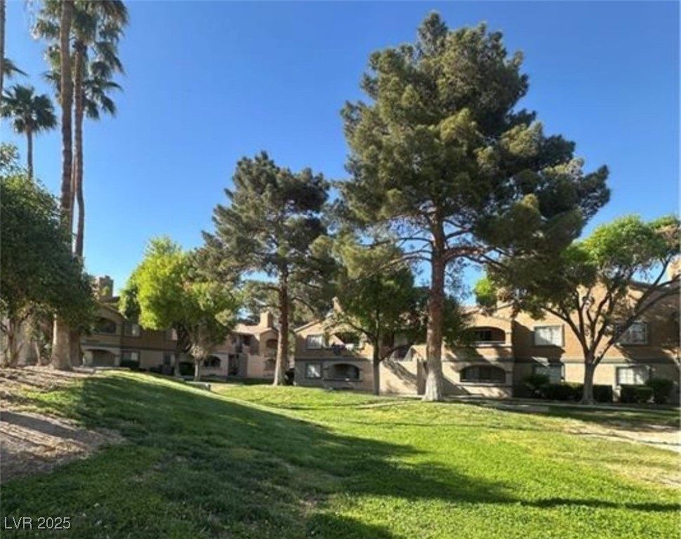 221 Mission Newport Lane, Unit 205 Las Vegas, NV 89107 - Photo 7 of 11 View of green lawn featuring a residential view