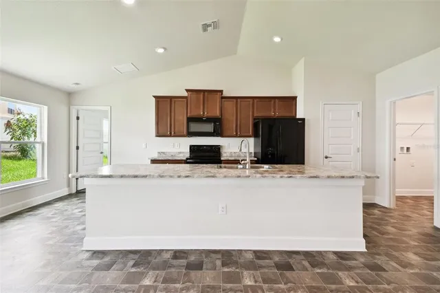 a kitchen with a sink and a stove top oven