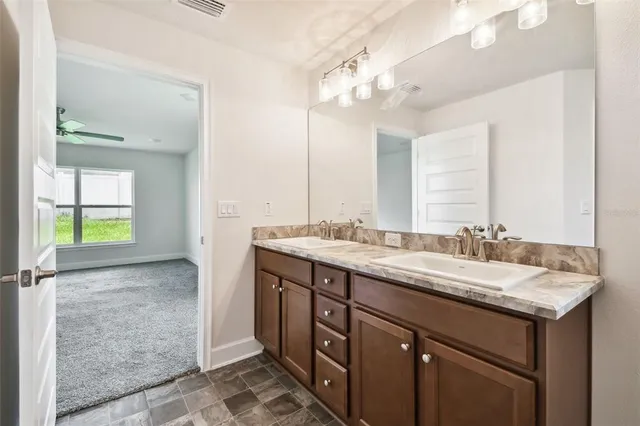 a bathroom with a granite countertop sink mirror and a