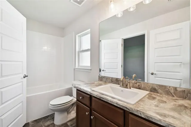 an empty room with a window and a fireplace