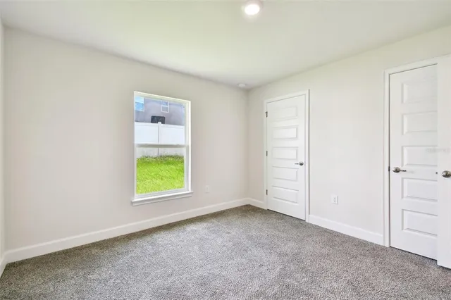 a bathroom with a granite countertop sink a toilet a mirror a bathtub and shower