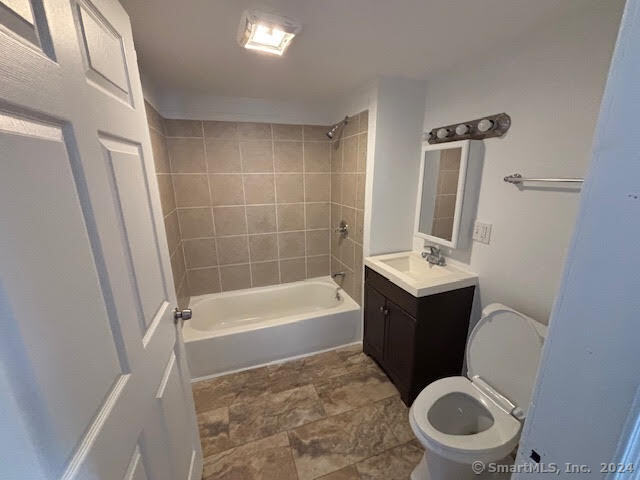 243 North Elm Street, Unit 3 Torrington, CT 06790 - Photo 6 of 7 a bathroom with a sink a toilet a mirror and bathtub