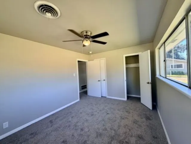 an empty room with a empty space and a ceiling fan
