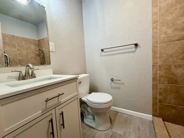 a bathroom with a sink toilet and shower