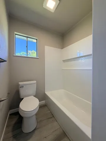 a white toilet sitting next to a bathroom sink