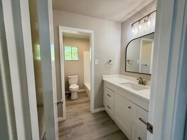 a spacious bathroom with a double vanity sink and a mirror