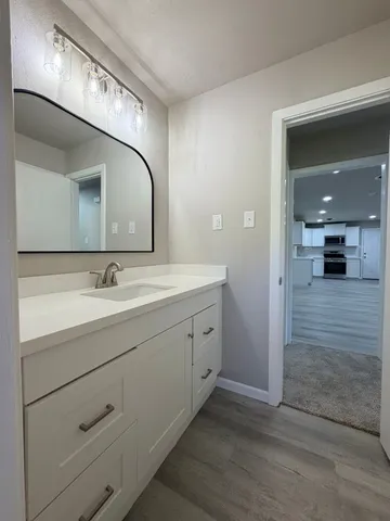 a spacious bathroom with a double vanity sink and a mirror