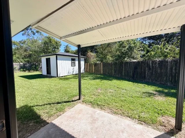a backyard of a house with a garden and deck