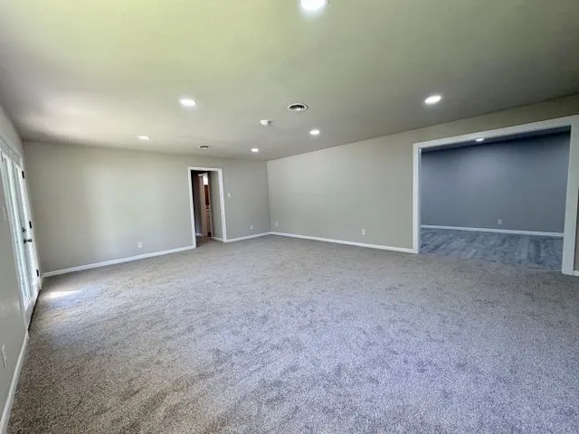 an empty room with closet and windows