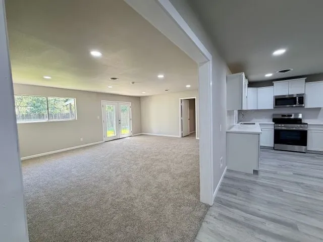 a view of kitchen with wooden floor and electronic appliances