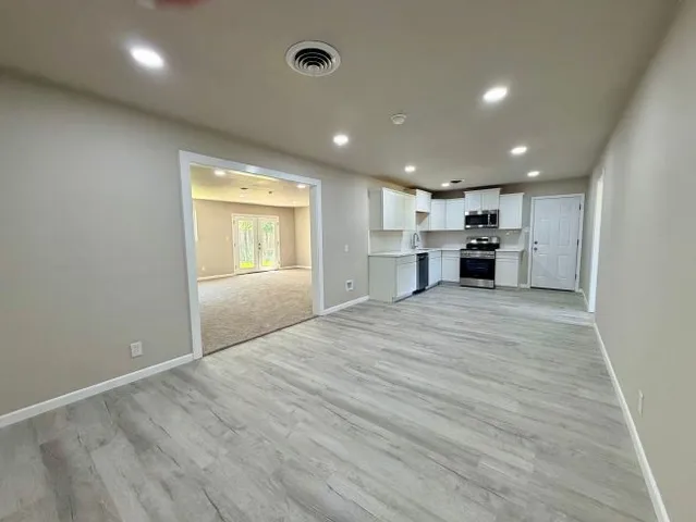 a view of a kitchen with a sink and a window