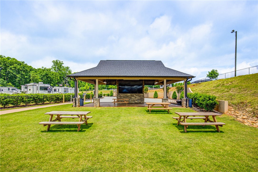 150 Dalton Drive, Unit 331/332 Pendleton, SC 29670 - Photo 11 of 29 A community gathering pavilion with multiple picnic tables sits on a verdant lawn.