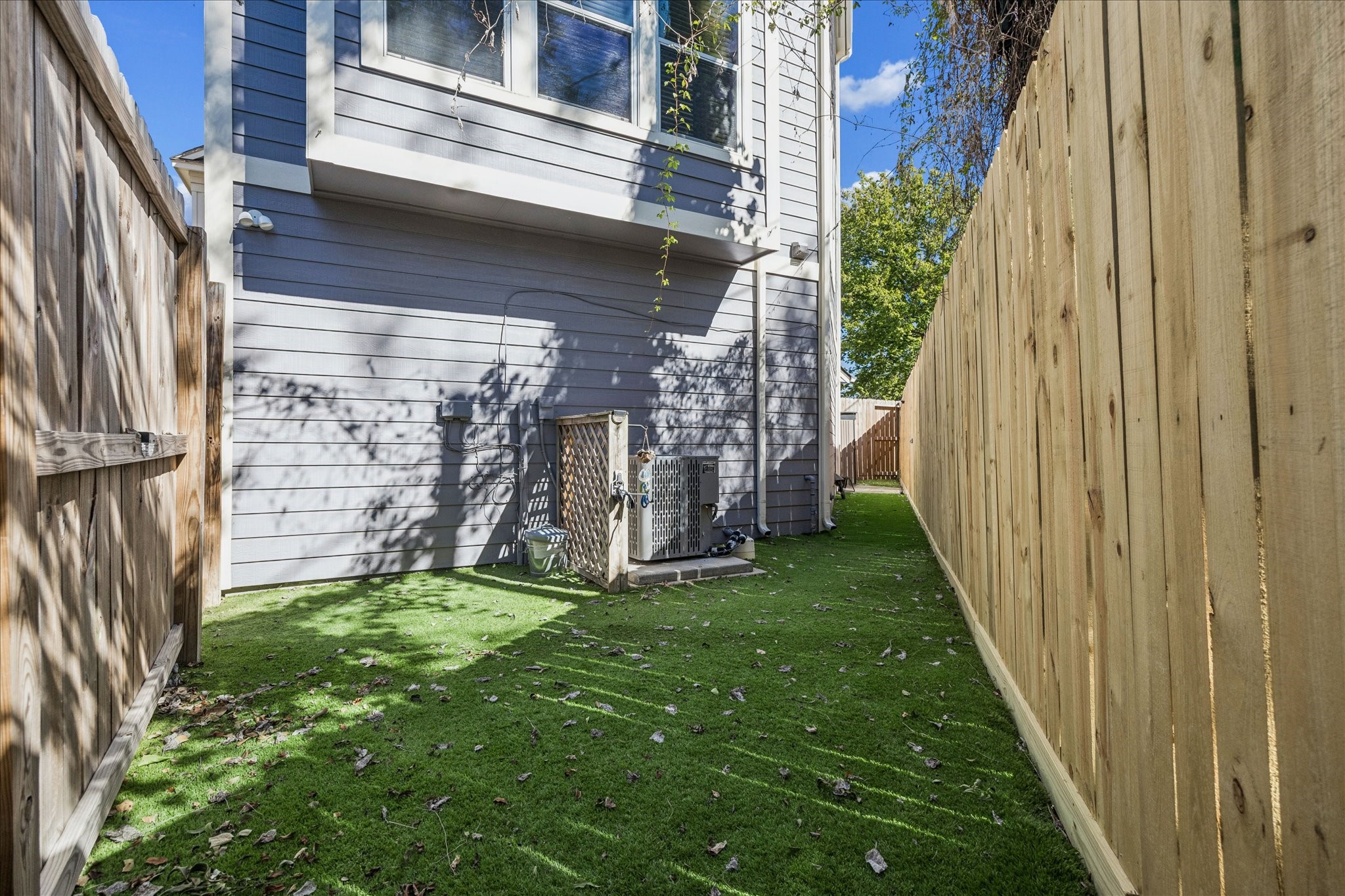 2607 Link Road Houston, TX 77009 - Photo 21 of 21 Plenty of green space in this back and side yard with artificial grass plus it is partially shaded by trees.