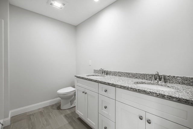 4 Sabrina Way, Unit G Feeding Hills, MA 01030 - Photo 16 of 16 a bathroom with a granite countertop toilet and sink