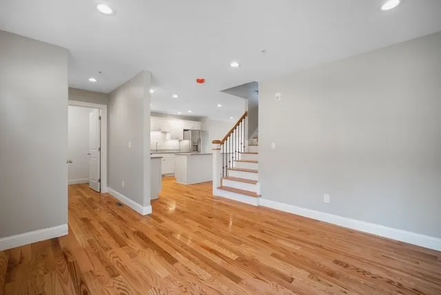 a view of a kitchen with wooden floor and stairs