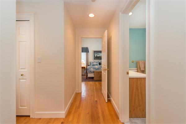 123 High Ridge Road Boxford, MA 01921 - Photo 17 of 29 a view of a hallway with wooden floor and a bathroom
