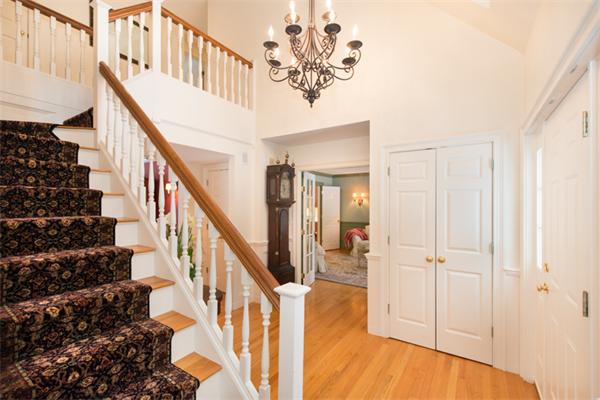 123 High Ridge Road Boxford, MA 01921 - Photo 4 of 29 a view of staircase with lots of frames on wall and a chandelier