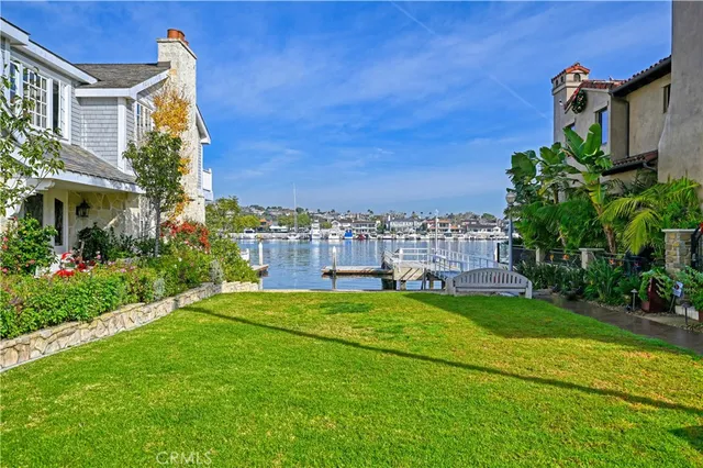 a view of a house with a big yard and potted plants