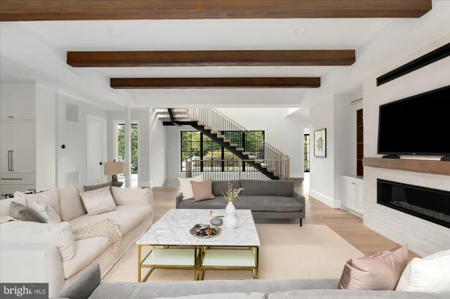 a kitchen with stainless steel appliances a stove a sink dishwasher and a refrigerator with wooden floor