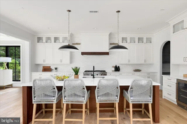 a large white kitchen with a large window