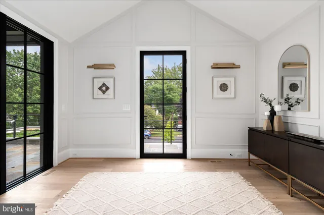 a living room with furniture a rug and a large window
