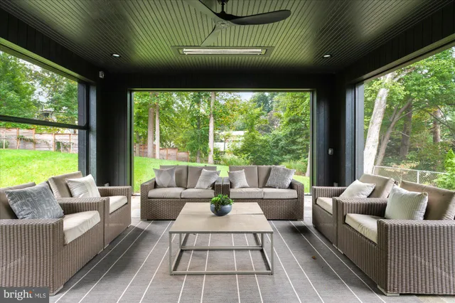 a living room with a bed furniture and a large window