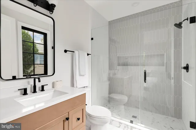a bathroom with a double vanity sink and large mirror