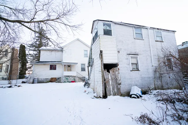 a view of a house with snow on the road