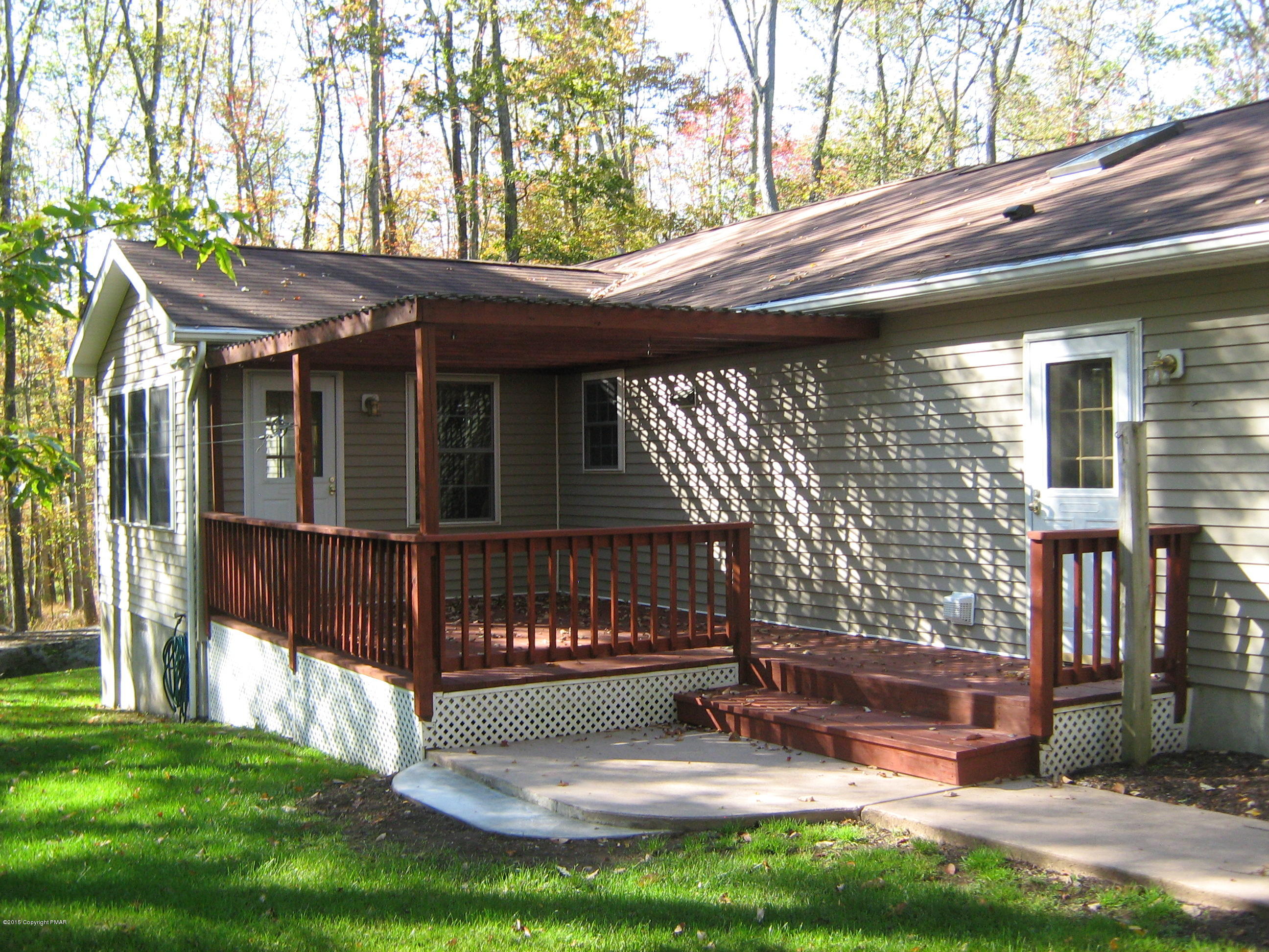 118 Bromley Road Henryville, PA 18332 - Photo 2 of 37 a view of a house with a small yard and wooden fence
