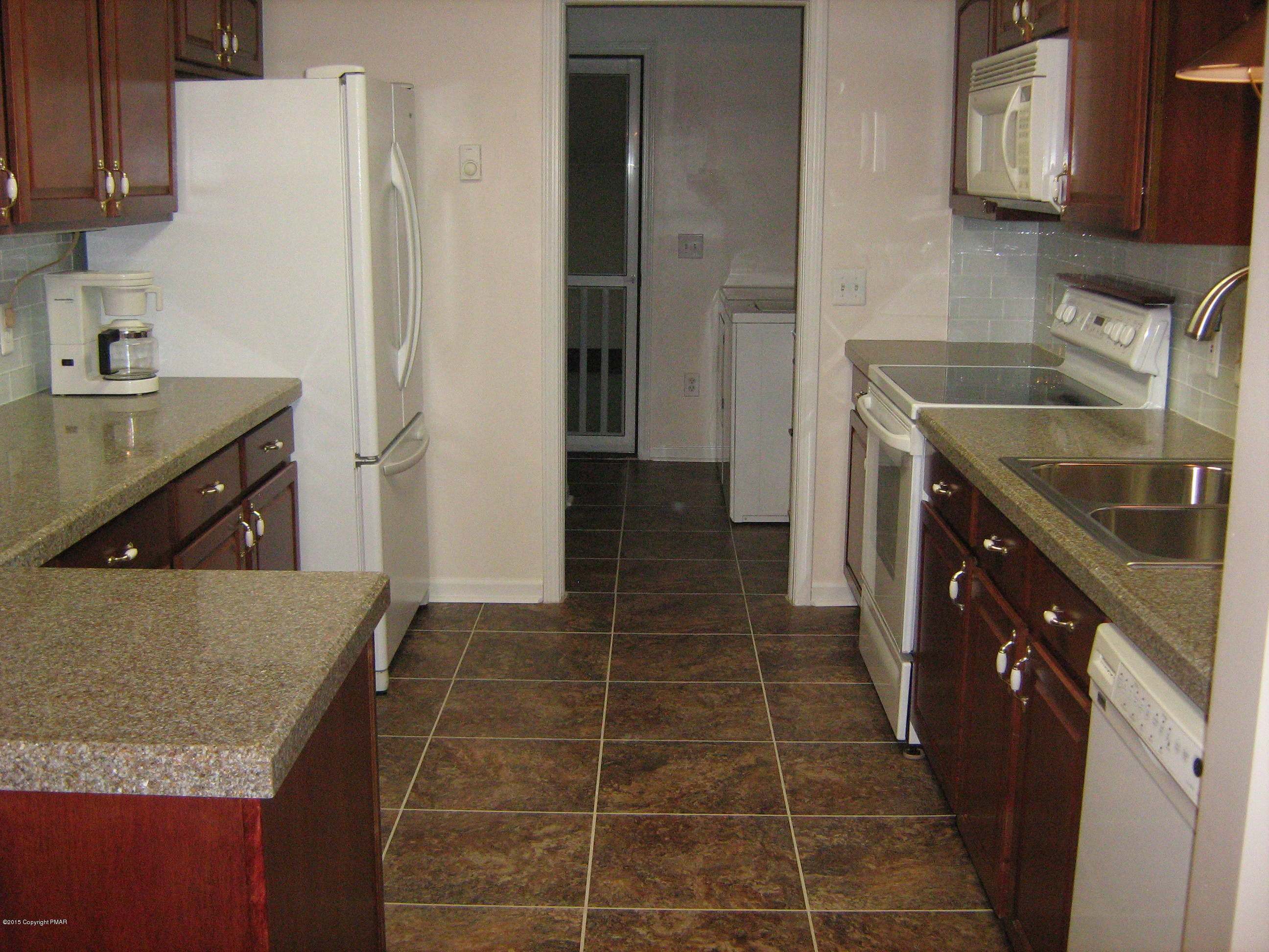 118 Bromley Road Henryville, PA 18332 - Photo 9 of 37 a kitchen with a sink stove and cabinets