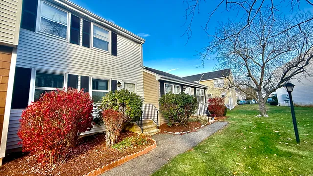 a front view of house and yard with green space