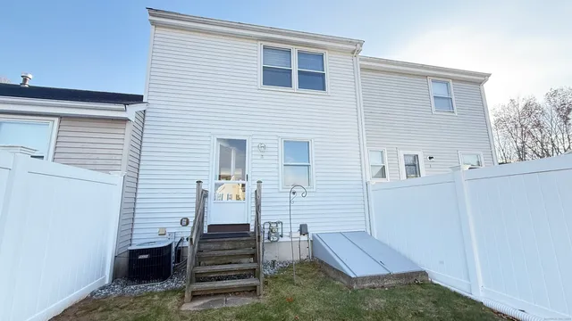 a view of a patio with couches and a refrigerator