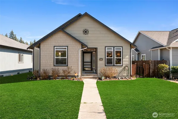 a front view of a house with a yard and garage