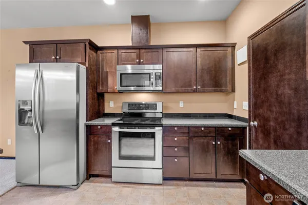 a kitchen with a stove and a refrigerator