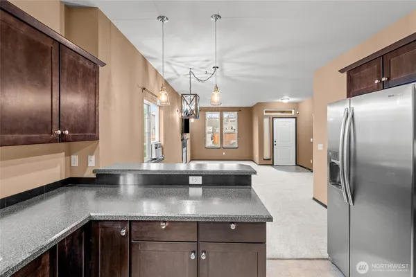 a kitchen with stainless steel appliances granite countertop a sink and a refrigerator