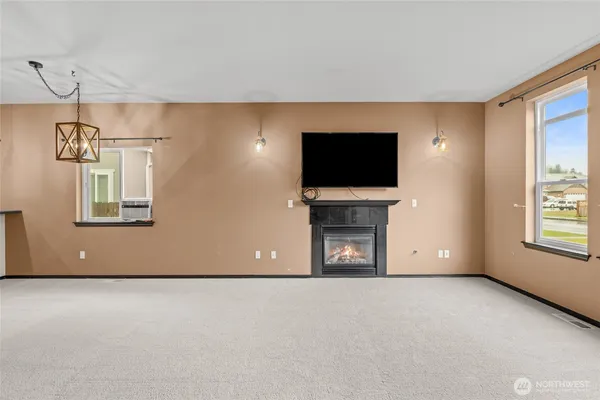 a view of empty room with a fireplace