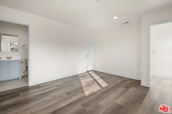 a view of an empty room and wooden floor