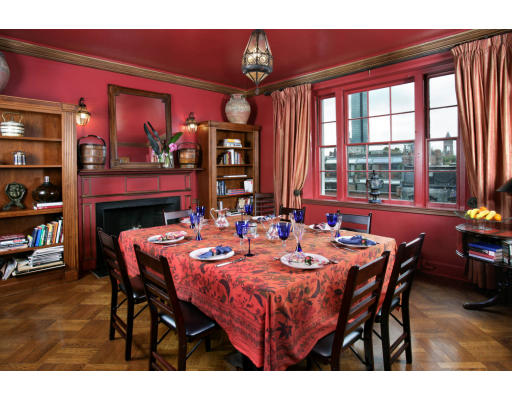 a dining room with a wooden table and chairs